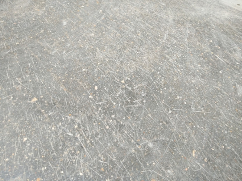 How do scratches in the concrete floor grinding process come from?